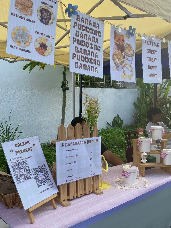 The market stall: tubs on the wooden stand with the gingham ribbons, banners overhead