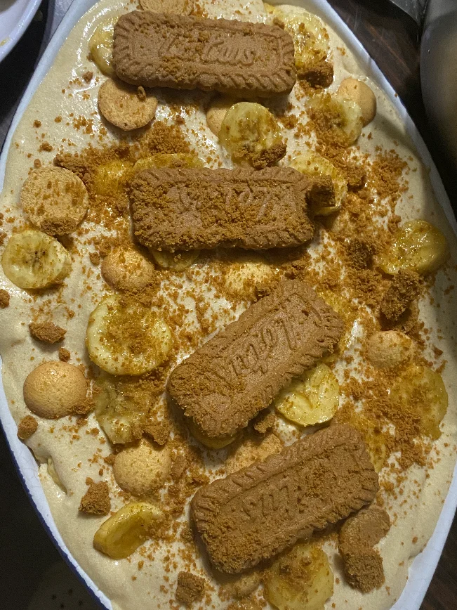 Behind the scenes: hands layering a tub, or a tray of fresh tubs before the lids go on